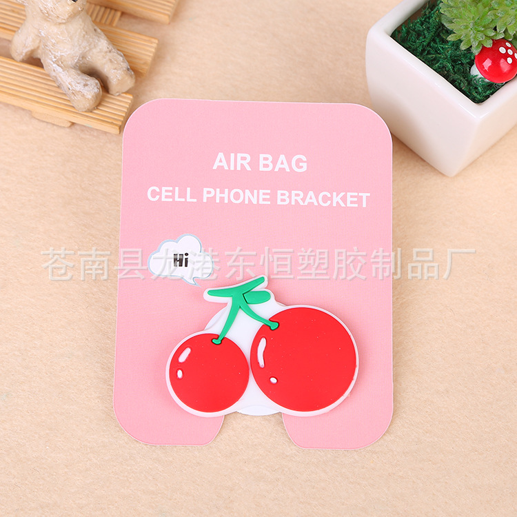 En stock al por mayor TikTok Cartoon creativo soporte de teléfono móvil puede soportar airbag soporte de teléfono móvil soporte de escritorio