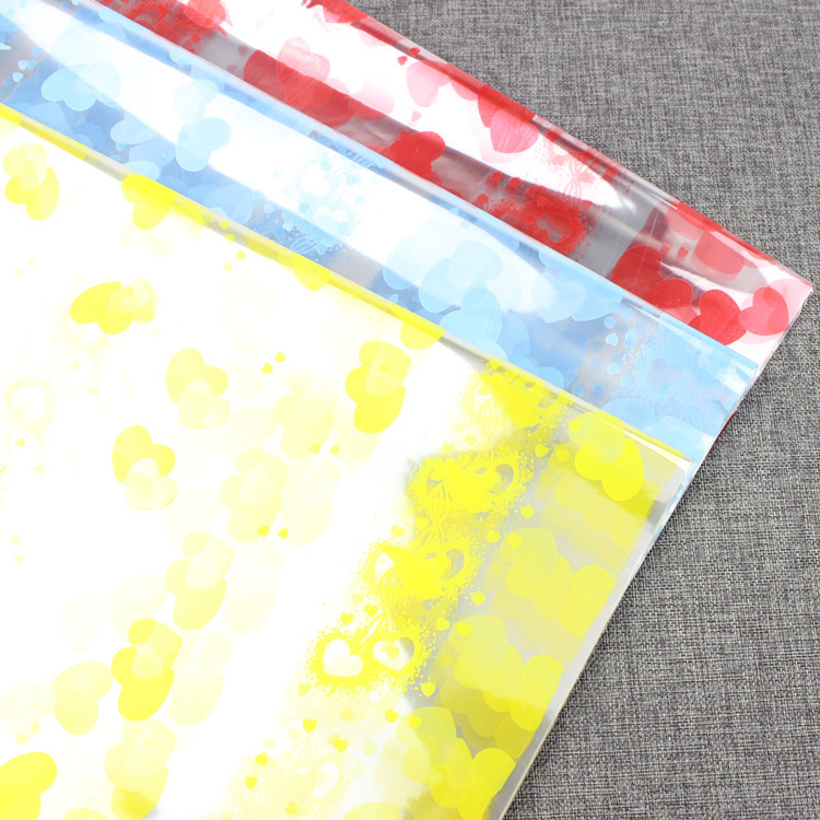 Flor envuelta en celofán impresión papel de plástico papel de regalo papel de embalaje transparente de Apple regalo flor material de embalaje al por mayor