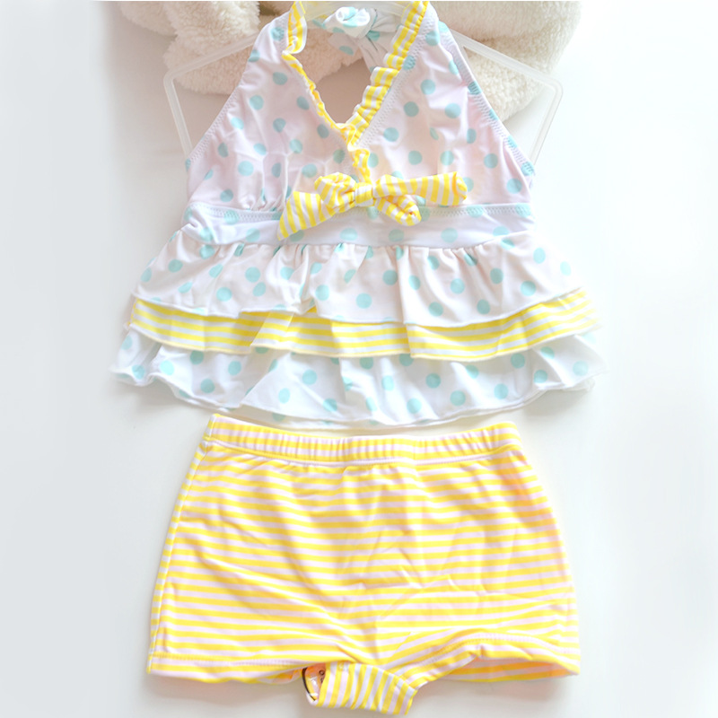 Blue dots and yellow stripes on white background
