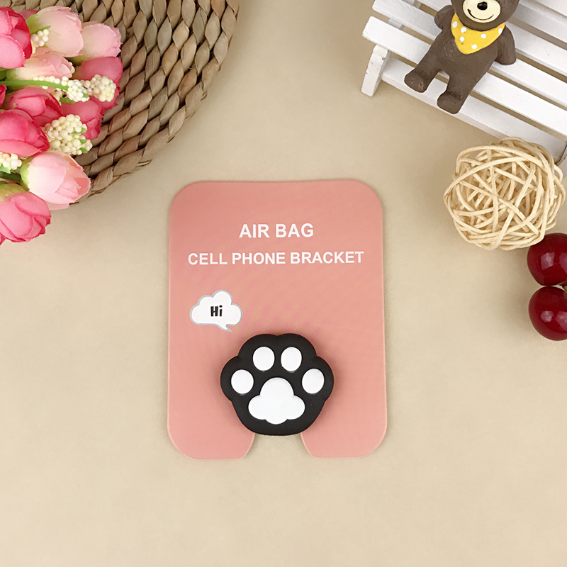 En stock al por mayor TikTok Cartoon creativo soporte de teléfono móvil puede soportar airbag soporte de teléfono móvil soporte de escritorio