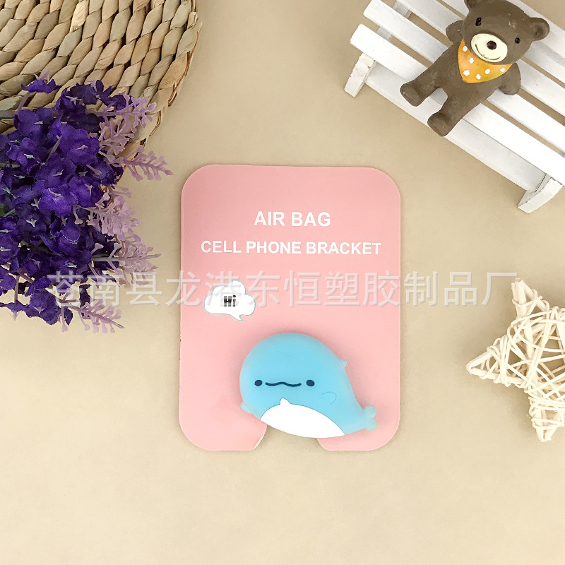 En stock al por mayor TikTok Cartoon creativo soporte de teléfono móvil puede soportar airbag soporte de teléfono móvil soporte de escritorio