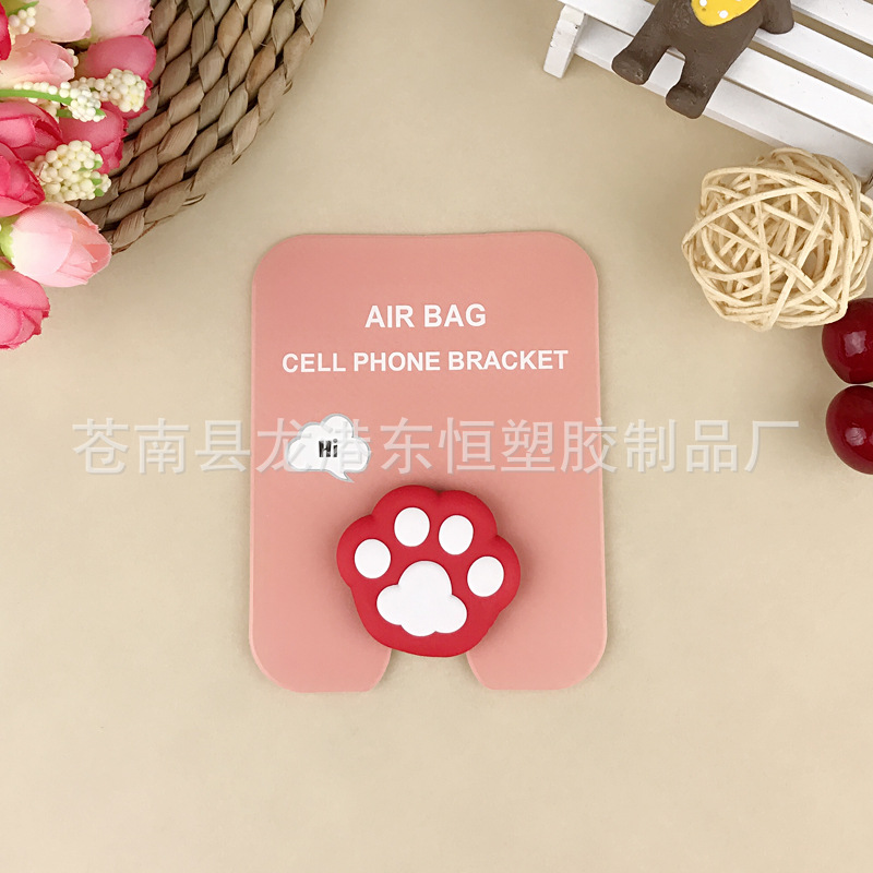 En stock al por mayor TikTok Cartoon creativo soporte de teléfono móvil puede soportar airbag soporte de teléfono móvil soporte de escritorio