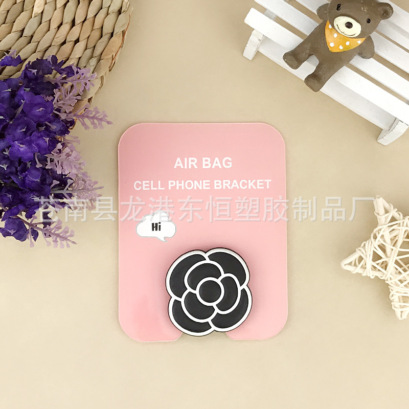 En stock al por mayor TikTok Cartoon creativo soporte de teléfono móvil puede soportar airbag soporte de teléfono móvil soporte de escritorio