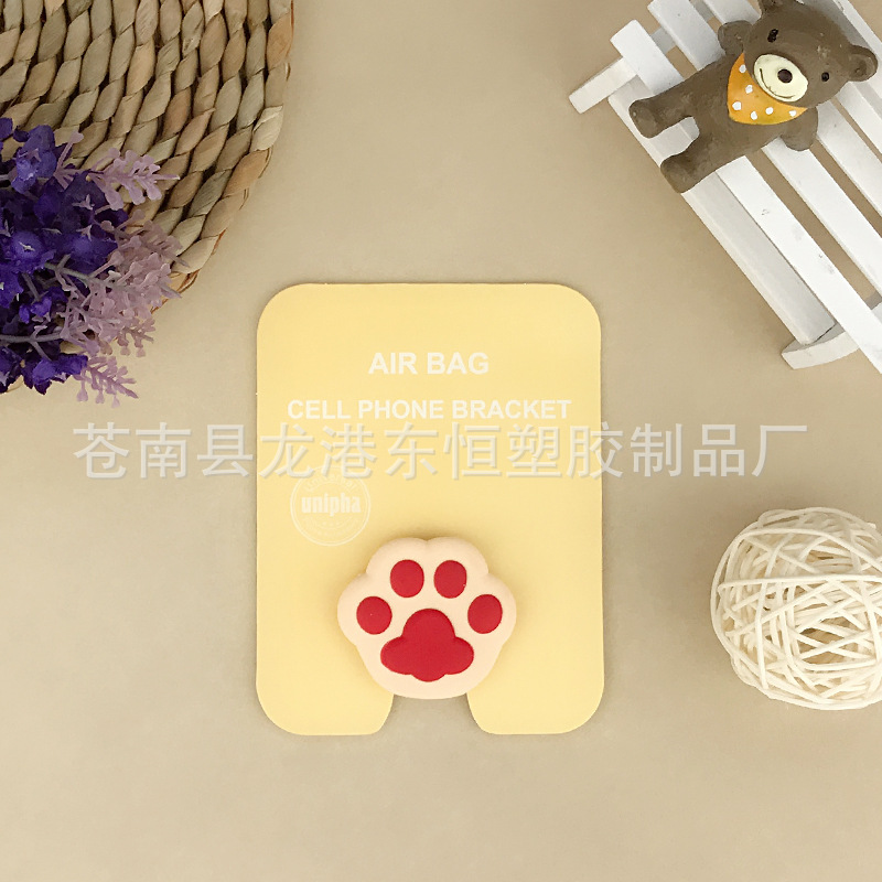 En stock al por mayor TikTok Cartoon creativo soporte de teléfono móvil puede soportar airbag soporte de teléfono móvil soporte de escritorio