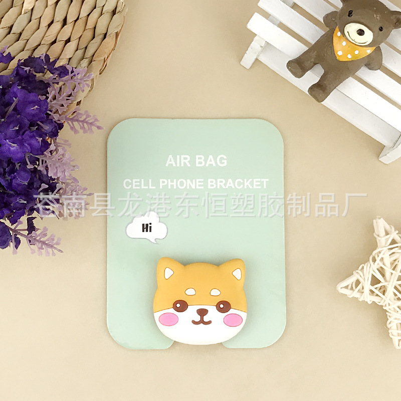 En stock al por mayor TikTok Cartoon creativo soporte de teléfono móvil puede soportar airbag soporte de teléfono móvil soporte de escritorio