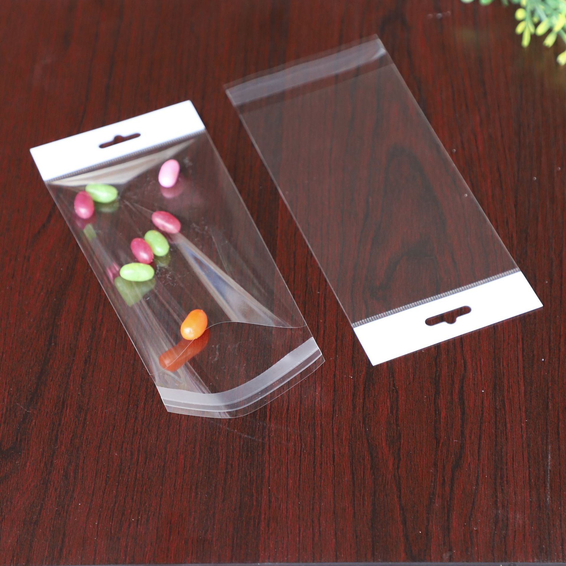 现货透明OPP圆孔飞机孔珠光膜卡头自封袋光版通用硅胶挂绳玩具袋