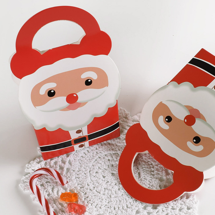 現物サンタクロースがキャンディー紙箱を持って赤いクリスマスハロウィーン専用キャンディープレゼント包装箱を卸売りする|undefined