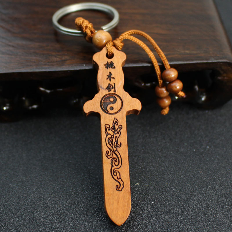 Factory direct wholesale car keychains, peach wood pendants, portable peach wood swords, wood carvings, handicrafts, 2 yuan 10 yuan shop stock