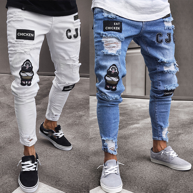 Moda transfronteriza europea y americana rasgada insignia juvenil estiramiento pantalones ajustados pantalones vaqueros de hip hop de los hombres pantalones de moda