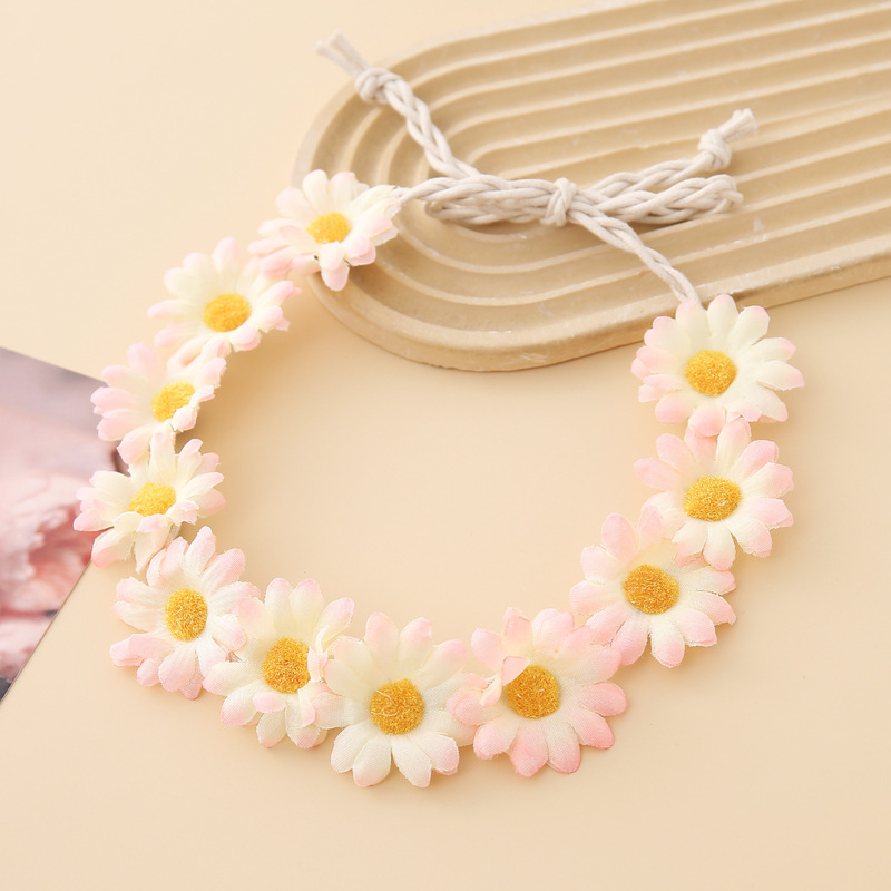 女性の女の子のヘアバンドは11輪の花の頭を編んで小さい太陽の花を持って旅行します。|undefined
