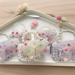 25韓国版の子供の斜めのショルダーバッグの新型の蝶結びの真珠のハンドバッグの小さい香風の子供のカバンの工場は直接販売します。