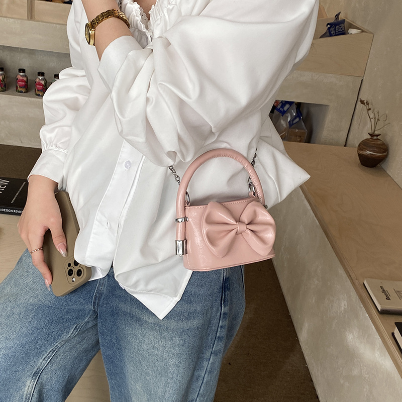 Nuevos bolsos de cadena coreanos para niños y niñas, bolsos de mini arco, bolsos de mano para niños, bolsos de comercio exterior transfronterizos