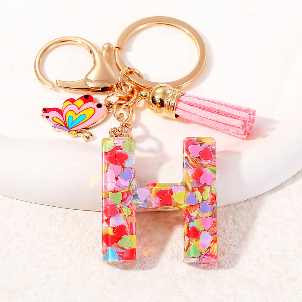 2024 puntos transfronterizos de resina de sequilla rosa 26 letras inglesas llavero colgante mariposa fringe accesorios