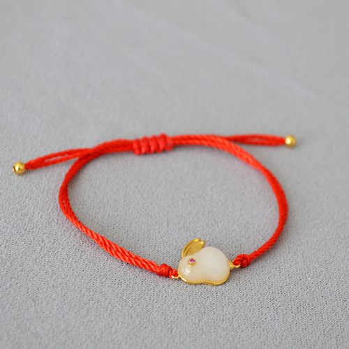 A unique, minimalist Chinese-style zodiac red rope braided Qinglong jade pendant bracelet with a circular clasp for adjustable closure, exuding elegance and personality.