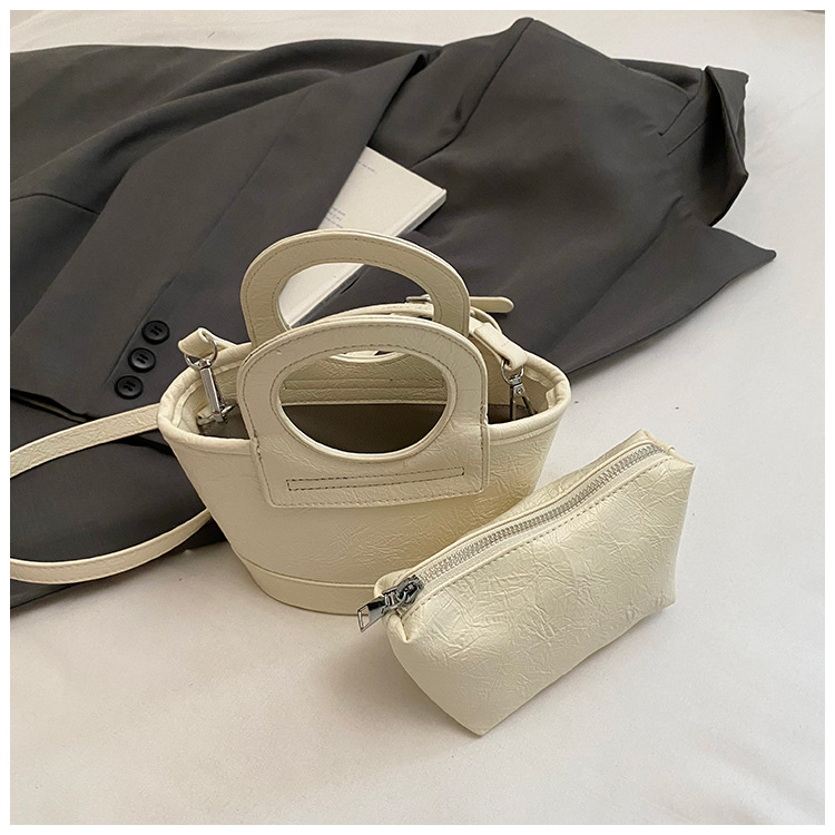 Bolso para mujeres 2026 nuevo nicho coreano de comida de mano cesta bolsa de cubo de textura alta de viaje mochila de hombro