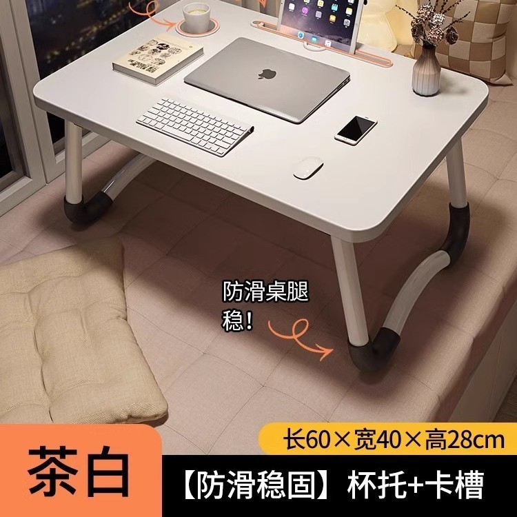 折り畳み可能なベッドの上の小さなテーブルは机のノートパソコンのテーブルを勉強します。|undefined
