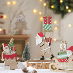 創意的なクリスマスの木の置物のデスクトップのクリスマスツリーは歓迎のブランドの老人の贈り物の包みの家にクリスマスの装飾を並べます。