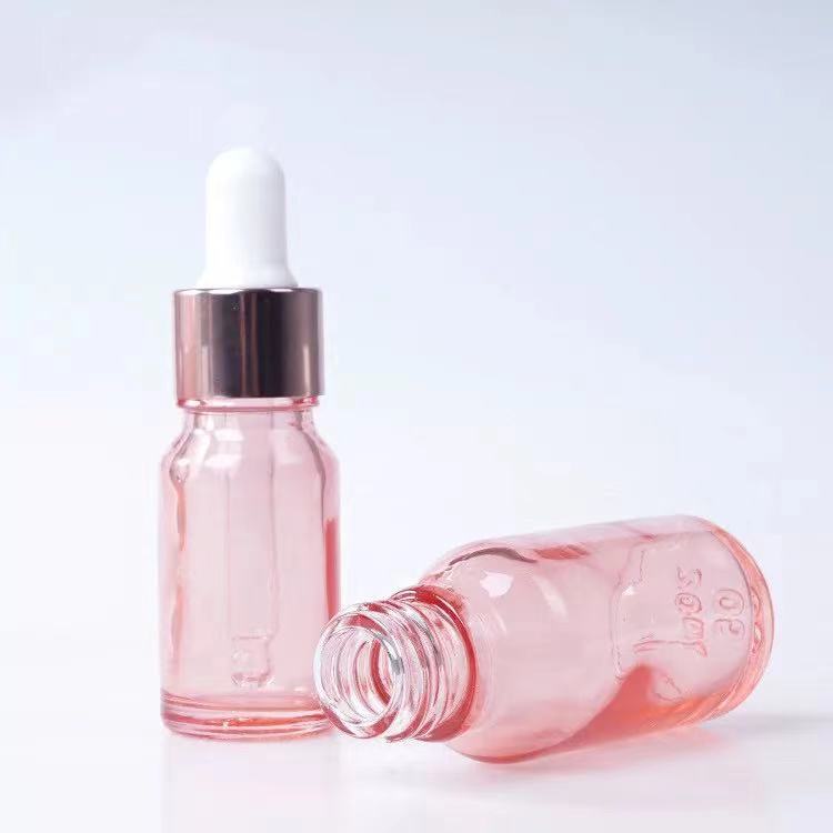 Venta al por mayor 10ml melocotón transparente vidrio Rosa botella de aceite esencial 20ml cosmética sub-botella Rosa anillo de oro botella de vidrio