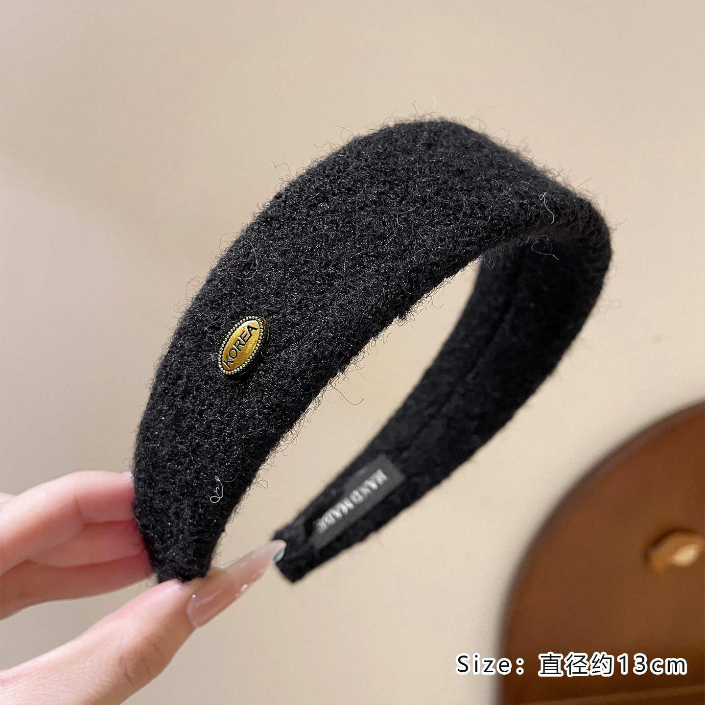 #212 black woolen oval gold label headband