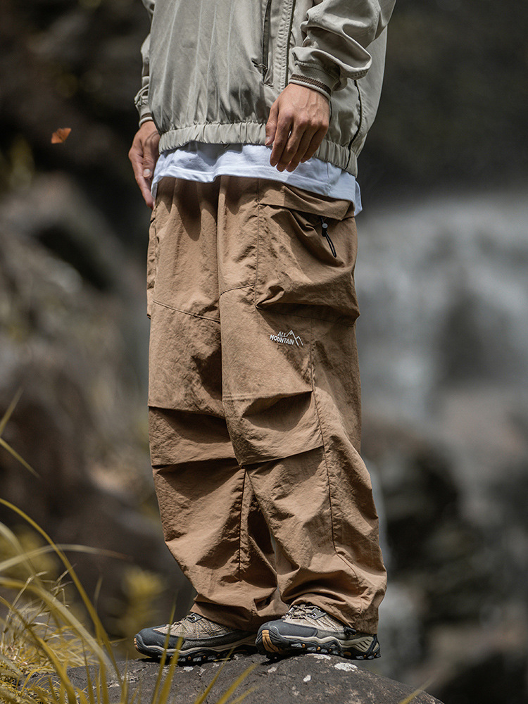 Pantalones de paracaídas con doble bolsillo grande plisado primavera nuevo estilo japonés funciones sueltas al aire libre pantalones de ocio anti-salpicaduras