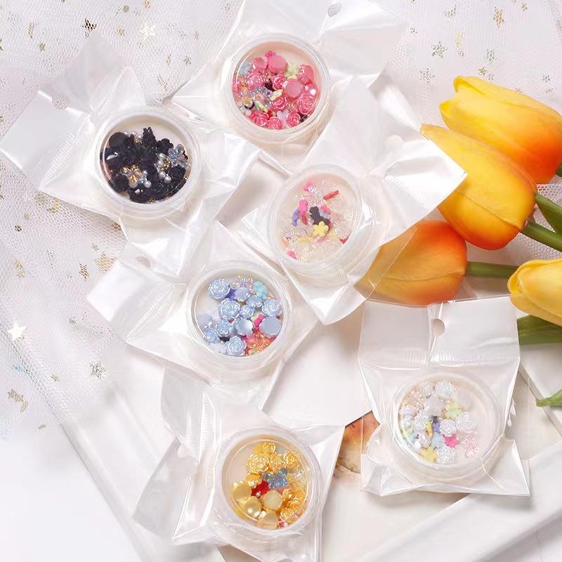 Nueva celebridad en línea suministros de uñas 3D multicolor de alto grado Camelia mariposa cinco pétalos flor bola de acero joyería de uñas diamante