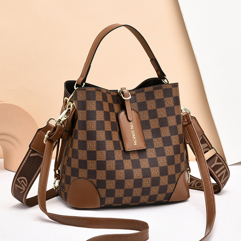 Bolsos bolsos de mujer bolsos de moda retro 2025 bolsos de nuevo estilo de gran capacidad y sentido de alta calidad bolso de cubo diagonal de un solo hombro mujeres