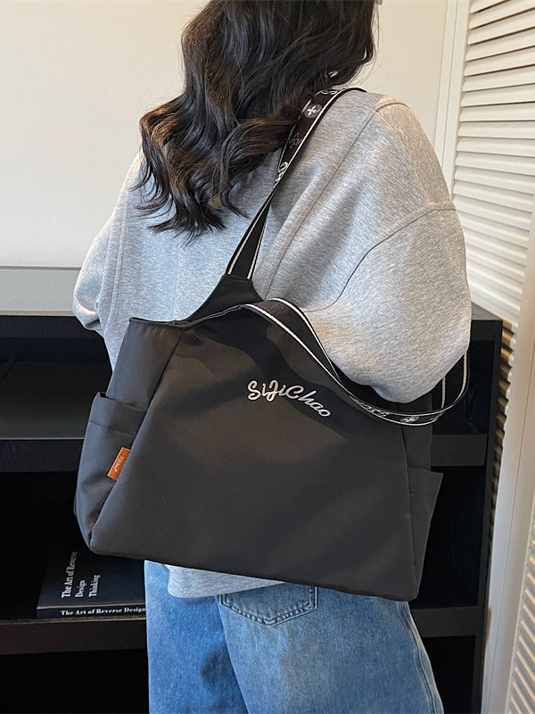 Bolsas de lona de moda de gran capacidad para mujeres 2026 nueva textura bordada letras bolsas de hombro de viaje simple bolsas de mano