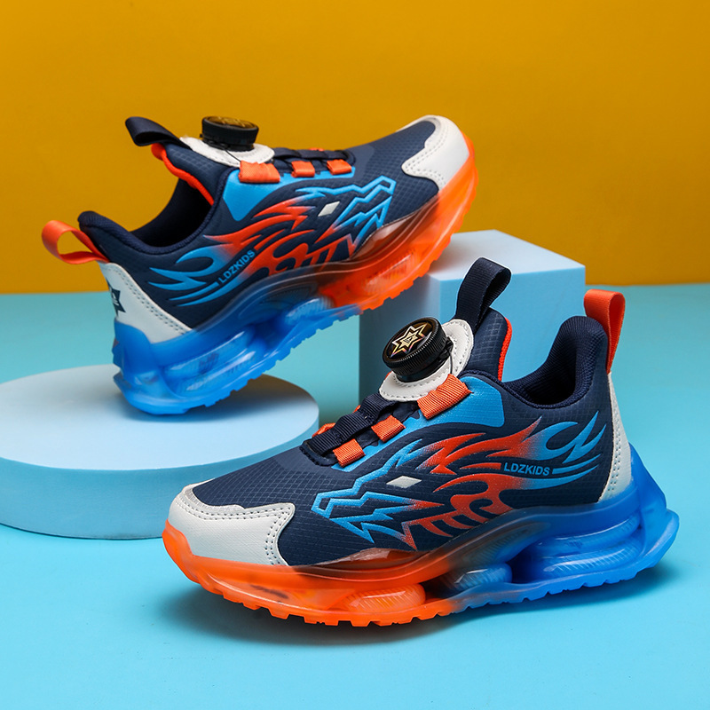 Venta al por mayor de zapatos para niños de mediana edad, zapatos con botones giratorios, modelos de primavera y otoño para estudiantes, una pieza de deportes, red de fideos para niños transpirable