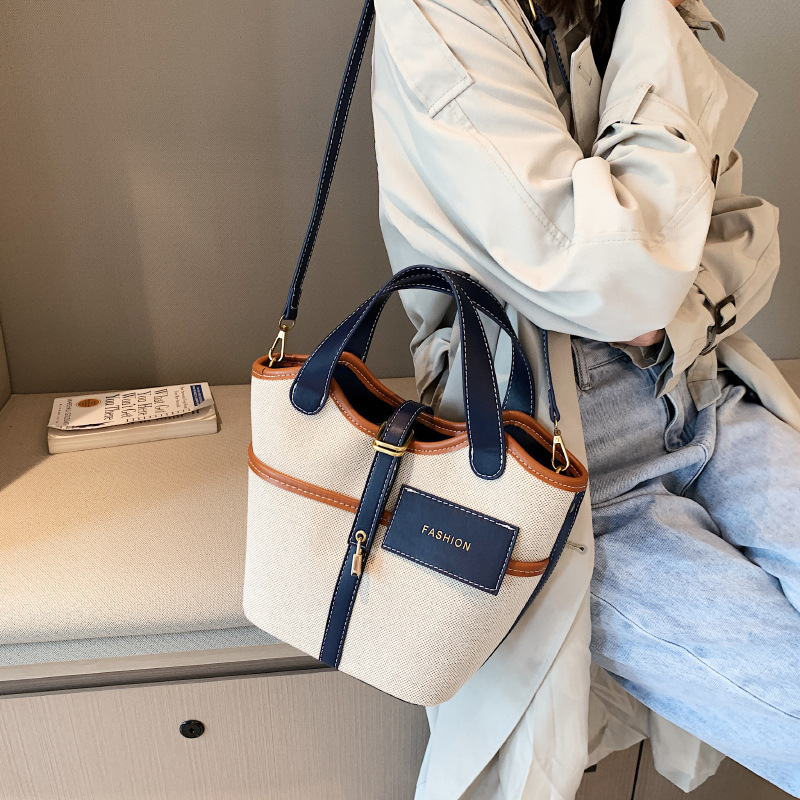 Bolso de lona para mujer 2026, nuevo diseño de nicho, bolso de mano tipo cubo, bolso retro de moda, bolso de hombro cruzado tipo cesta