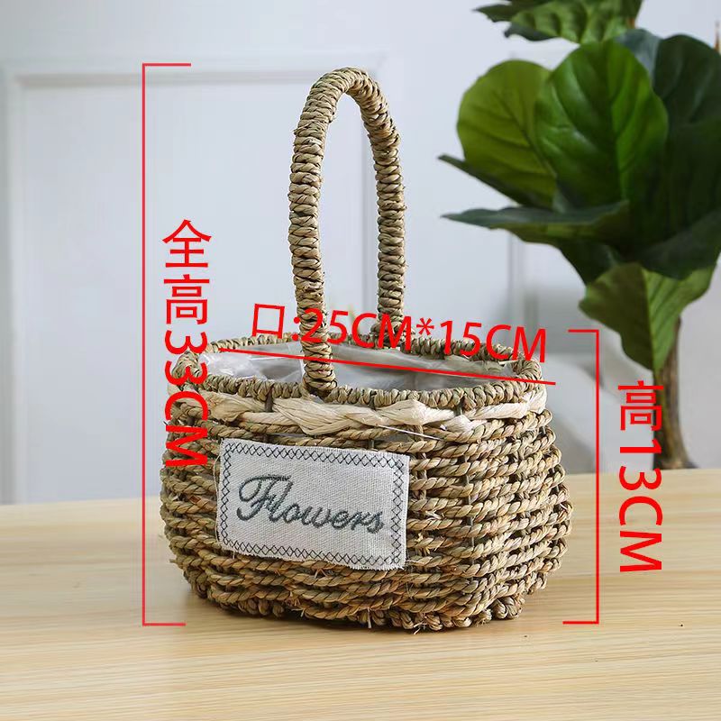 Fabricantes de cestas de flores ovales rectas de paja hechas a mano en stock al por mayor cestas de flores de paja portátiles decoración de viento pastoral