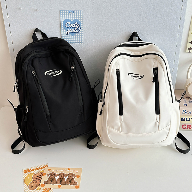 Fabricantes de mochilas escolares, estudiantes universitarias al por mayor, simples y versátiles, versión coreana de mochilas de ocio de nicho engrosadas