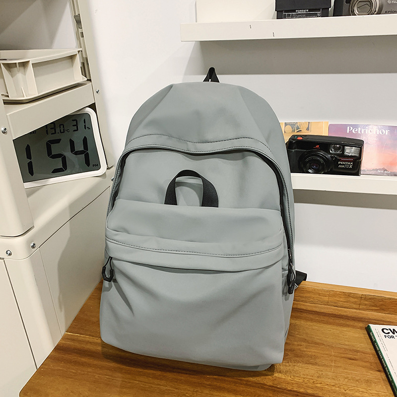 Las chicas japonesas de bolsos de lona son antiguas, impermeables, de color sólido, bolsos de nylon, Campus simple y versátil mochilas escolares para hombres de moda.