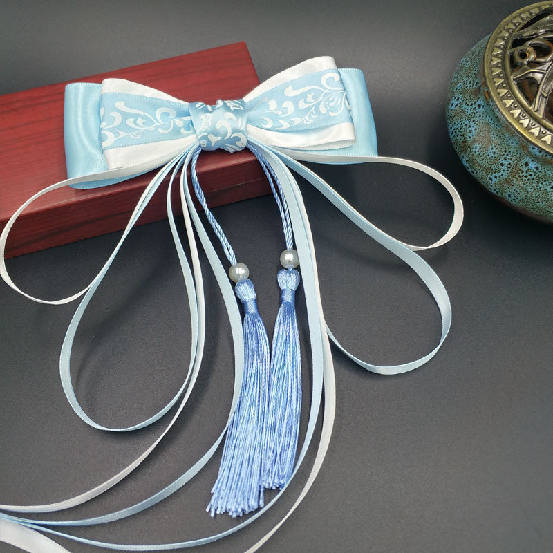 Blue and white hairgrip with tassels