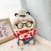 Grizzly ear hat + a row of red love + black framed glasses + blue jeans + small guitar