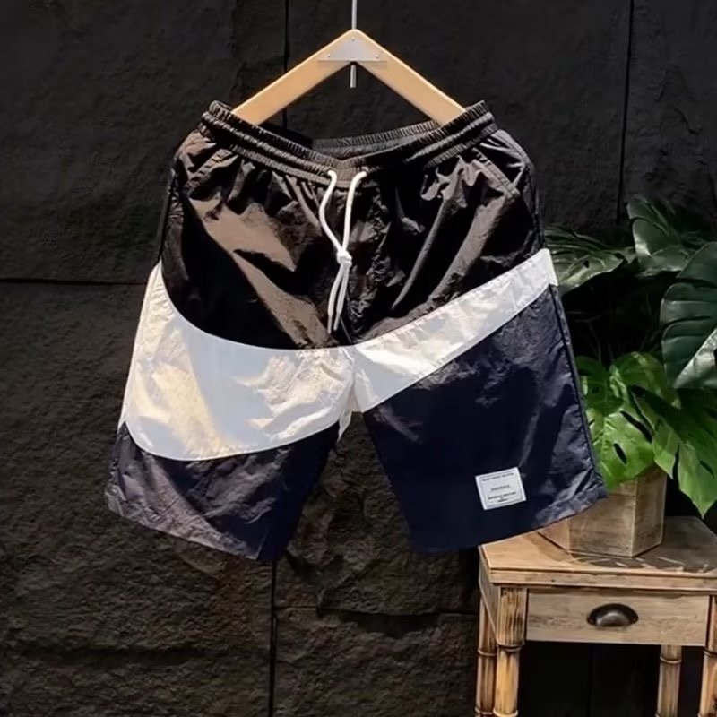 Pantaloncini estivi con etichetta di moda abbinati a colori casual larghi e versatili per pantaloncini da spiaggia sportivi ad asciugatura rapida da uomo_voghion.com