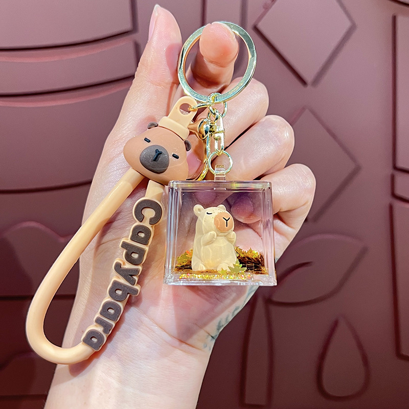 Botella creativa de aceite flotante Capibara Dolphin Keychain bolsos de automóviles exquisitos colgantes de arena flotante regalos al por mayor