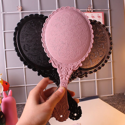 Retro handheld makeup mirror with European floral edge handle mirror hole design, high-definition mirror surface small mirror