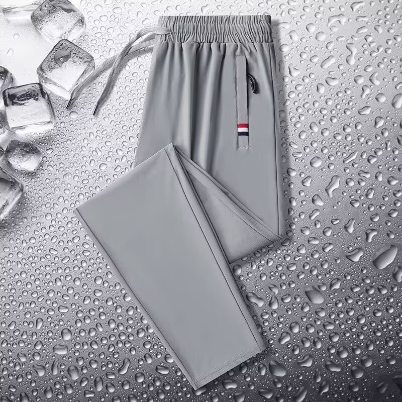Camisas y menos ropa, pantalones de seda de hielo, pantalones de chándal elásticos finos de verano, pantalones rectos de hombre con cremallera de bolsillo al por mayor al por mayor