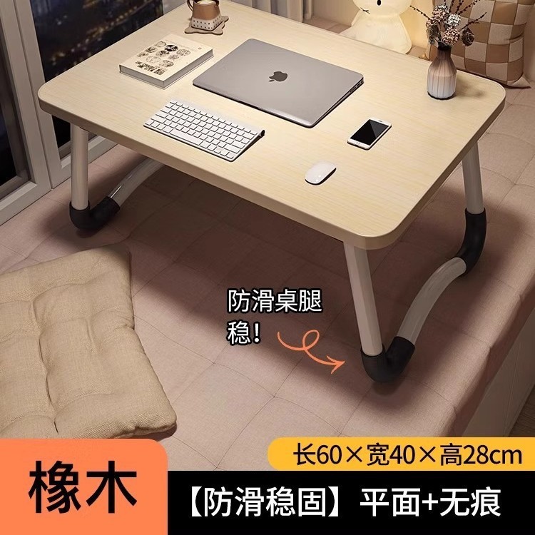 折り畳み可能なベッドの上の小さなテーブルは机のノートパソコンのテーブルを勉強します。|undefined