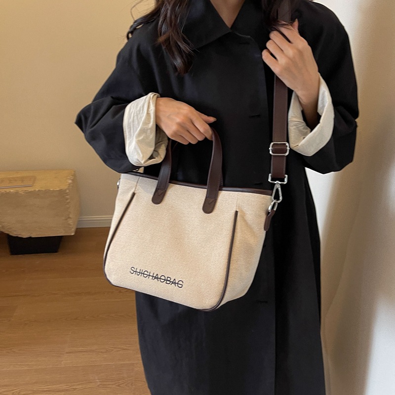 Estilo coreano de moda de contraste de color lienzo bolsa de mano portátil para las mujeres 2023 transfronteriza nueva textura de alto grado de hombro bolsa de mensajero