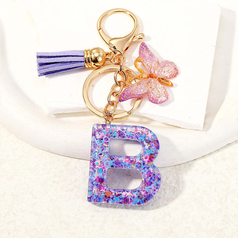 Mayorista transfronterizo mariposa esquinilla iniciales llavero de cristal goteo llavero de letras bolsos colgante