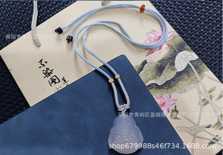 파란색과 회색 밧줄이 달린 흰색 칼세도니 부처님