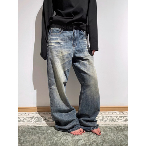 Vintage punk-style straight-leg, low-rise, slightly flared denim trousers with embroidery and a flowing, relaxed fit.