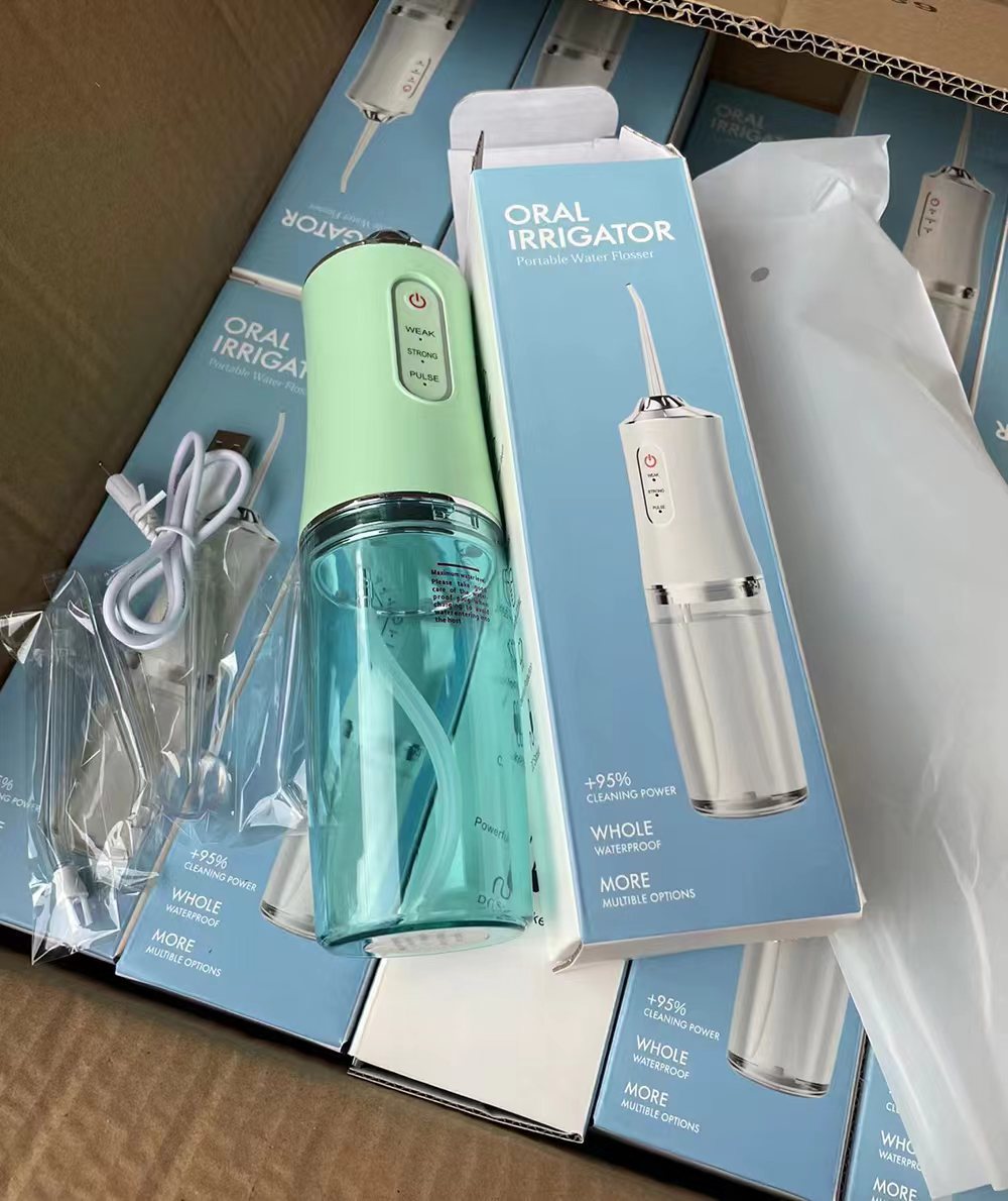 電動歯抜き器の水の歯を洗う機の神器の歯石の口腔の矯正の専用の携帯の動力は力強くて国境を越えます。