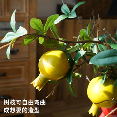 Selected fake pomegranate fruit decorative pieces with faux flowers and simulated green and red pomegranate branches for wholesale.