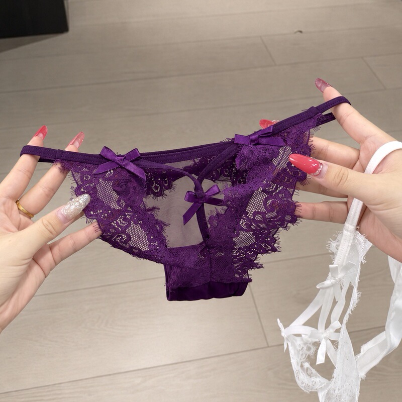 European and American style sexy women's lace hollow-out thong panties with straps, criss-cross design, bow detail, and sheer fabric