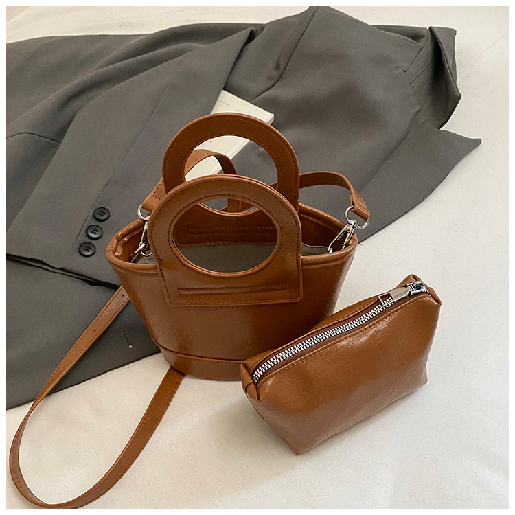 Bolso para mujeres 2026 nuevo nicho coreano de comida de mano cesta bolsa de cubo de textura alta de viaje mochila de hombro