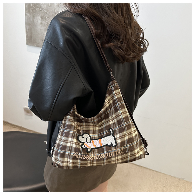 A new 2024 trendy and stylish backpack for women, featuring a cartoon checkered single-shoulder crossbody bag and a tote bag undefined