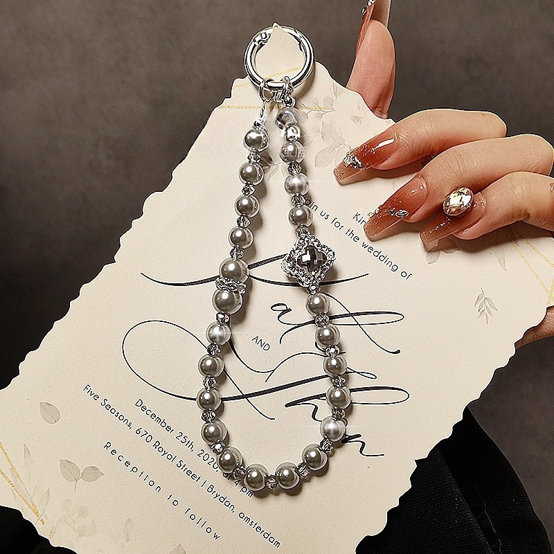 Stylish rhinestone-encrusted four-leaf clover beaded phone lanyard, Chanel-style pearl phone chain pendant, short keychain ornament