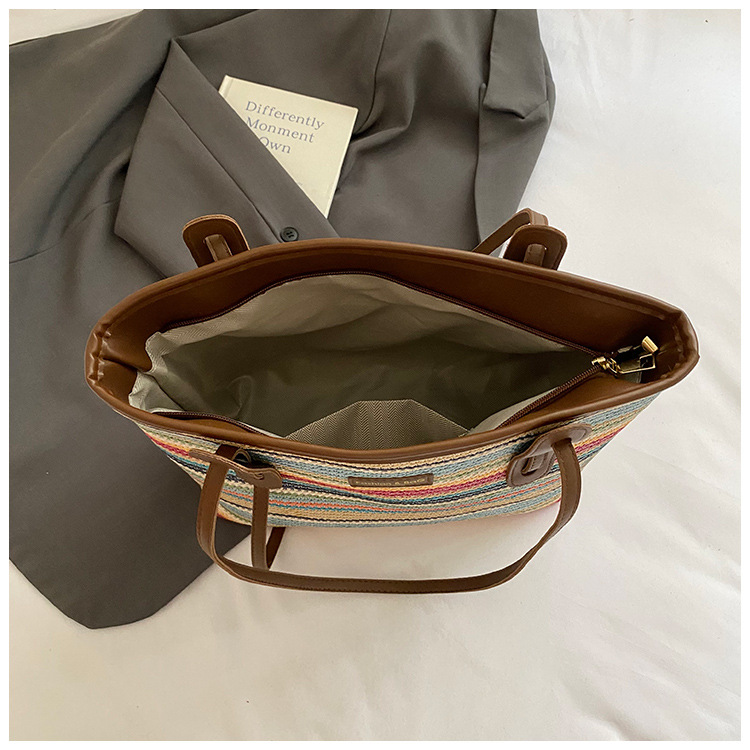 This is a new 2025 summer beach-style women's bag with a simple and versatile hand-held design. It's a single-shoulder vacation woven bag undefined